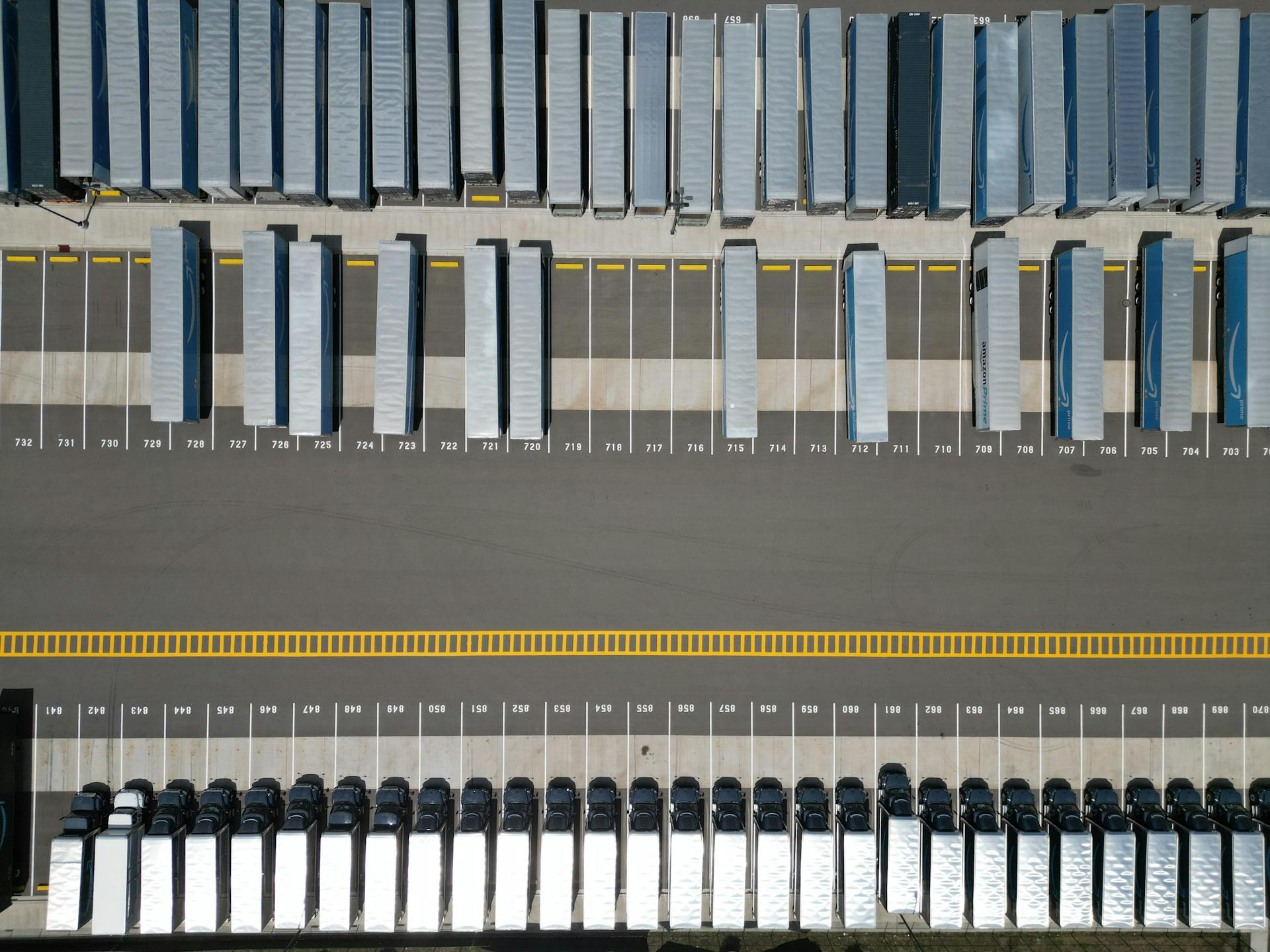 Aerial view of semi-trucks parked in a distribution yard